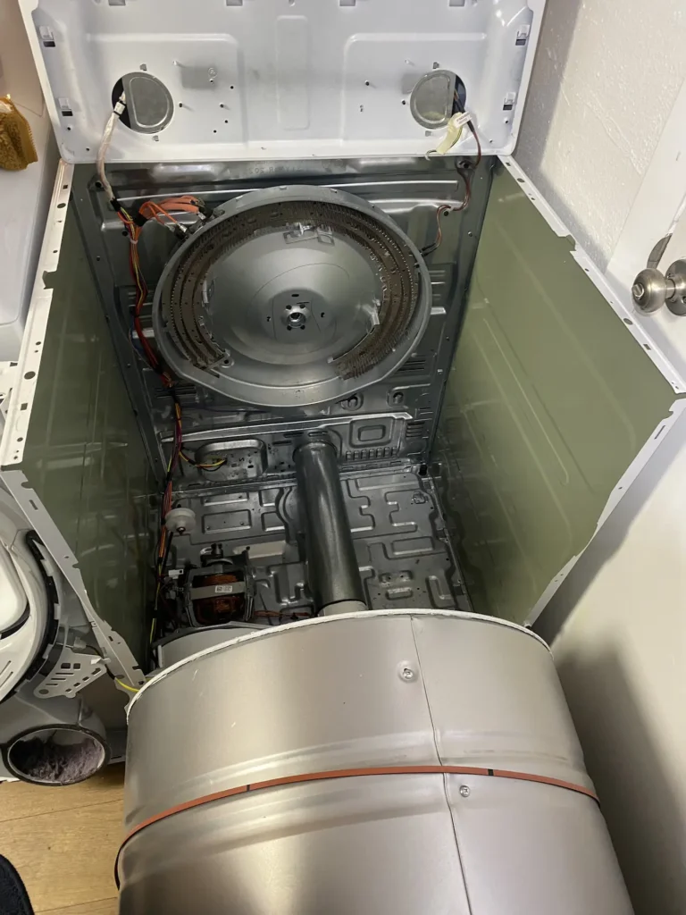 Dryer disassembled for repair showing heating element, blower housing, and internal components during professional dryer diagnostic service in Denver, Colorado.