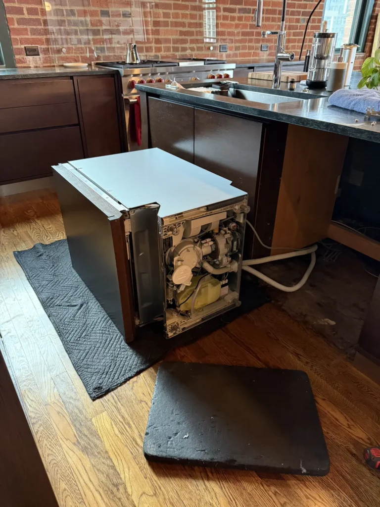Refrigerator repair technician performing sealed system repair in Denver, CO